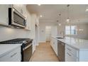 Modern kitchen with white cabinets and stainless steel appliances at 200 Dahlia Dr, Woodstock, GA 30188