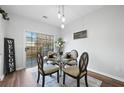 Bright dining area features a glass table with four chairs and a view of the backyard at 10900 Wittenridge Dr # D10, Alpharetta, GA 30022