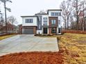 Modern home with wood and white siding, two-car garage, and landscaping at 2255 Shallowford Rd, Marietta, GA 30066