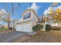 Two-story house with double garage and autumn foliage at 2213 Asquith Sw Ave, Marietta, GA 30008