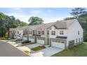 Row of townhouses with attached garages and landscaping at 349 Sound Cir # 133, Stockbridge, GA 30281