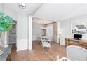 Bright dining room with hardwood floors, white table, and chandelier at 124 Wallnut Hall Cir, Woodstock, GA 30189