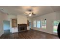 Spacious living room with wood-look flooring, fireplace, built-in shelves, and large windows at 236 Harmony Ridge Dr, Temple, GA 30179