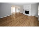 Spacious living room with wood-look flooring, a fireplace, and large windows at 5760 Lakeview Dr, Powder Springs, GA 30127