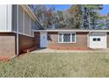 House front entrance with diamond pane window at 5431 E Wind Sw Dr, Lilburn, GA 30047