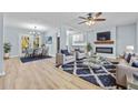 Open living and dining area with fireplace and hardwood floors at 111 Charles Pl, Cumming, GA 30040