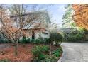 House exterior showcasing stone accents and a driveway at 1845 Branch Valley Dr, Roswell, GA 30076