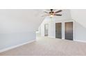 Large bedroom with carpeted floor, ceiling fan, and two closets at 106 Red Oak Ln, Carrollton, GA 30116