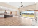 Open living space with kitchen island, hardwood floors, and sliding doors to a view at 106 Red Oak Ln, Carrollton, GA 30116