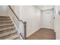 Modern staircase with gray carpeting and a white railing at 467 Daffodil Ln, Mcdonough, GA 30253