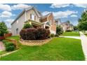 Two-story house with gray siding and a landscaped yard on a hillside at 2910 Blake Towers Ln, Buford, GA 30519