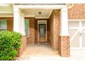 Front entrance with a decorative door and brick columns at 2910 Blake Towers Ln, Buford, GA 30519