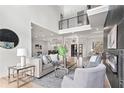 Living room with two-story ceiling, fireplace, modern decor, and natural light at 1198 Milmar Nw Dr, Atlanta, GA 30327