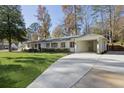 Front view of a renovated white ranch house with a long driveway at 436 Valley Brook Ne Dr, Atlanta, GA 30342