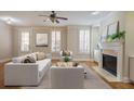 Spacious living room featuring hardwood floors, fireplace, and large windows at 5104 Davenport Pl, Roswell, GA 30075