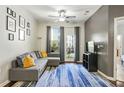 Living room with hardwood floors, sectional sofa, and balcony access at 870 Nw Mayson Turner Road # 1127, Atlanta, GA 30314