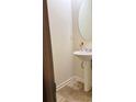 Small half bathroom with pedestal sink and oval mirror at 304 Morning Star Drive Dr, Temple, GA 30179