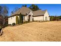 Side view of a brick home with a landscaped yard at 1560 Tapestry Rdg, Lawrenceville, GA 30045