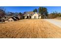 Front view of a brick home with a driveway and dry lawn at 1560 Tapestry Rdg, Lawrenceville, GA 30045