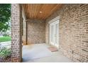 Covered back patio with brick flooring and French doors at 333 Brownstones Ne Cir, Atlanta, GA 30312
