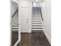 Bright entryway with hardwood floors, stairs, and a full-length mirror at 333 Brownstones Ne Cir, Atlanta, GA 30312
