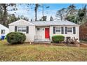 Quaint brick ranch house with red front door and lush green lawn at 2671 Tilson Rd, Decatur, GA 30032