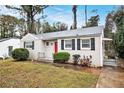 Charming brick ranch home with red door and well-maintained lawn at 2671 Tilson Rd, Decatur, GA 30032