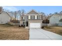 Two-story home with gray siding, brick accents, and a two-car garage at 153 Fresh Laurel Ln, Locust Grove, GA 30248