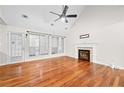 Spacious living room featuring hardwood floors, a fireplace, and a view to the kitchen at 2849 Weston Brook Ln, Duluth, GA 30096