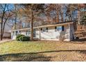 Side view of the house, nestled among trees at 195 Pinehurst Dr, Stockbridge, GA 30281