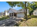 Ranch style home with a large driveway and mature trees at 5955 Raventree Ct, Atlanta, GA 30349