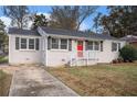 Gray brick ranch house with red front door and landscaping at 1742 Lynn Ln, Decatur, GA 30032