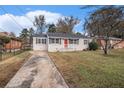 Ranch home with gray brick exterior, red door, and a long driveway at 1742 Lynn Ln, Decatur, GA 30032