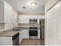 Renovated kitchen, featuring white cabinets, granite countertops, and stainless steel appliances at 1742 Lynn Ln, Decatur, GA 30032