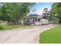 Front view of a charming ranch home with a red door and well-manicured lawn at 1396 Iron Gate Blvd, Jonesboro, GA 30238