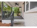 Gray porch with steps, railing, and ceiling fan offers a relaxing outdoor space at 1396 Iron Gate Blvd, Jonesboro, GA 30238