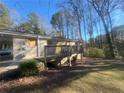 Side view of ranch house showing deck and wooded backyard at 2785 Battle Forrest Dr, Decatur, GA 30034