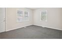 Bright bedroom with neutral walls and carpet, featuring two windows at 2259 Whites Mill Rd, Decatur, GA 30032