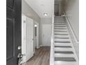Bright entryway with stairs, wood-look floors, and neutral walls at 5667 Cascade Sw Run, Atlanta, GA 30336