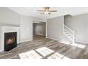 Living room with fireplace, wood-look floors, and neutral walls at 5667 Cascade Sw Run, Atlanta, GA 30336