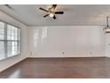 Bright living room with large windows, ceiling fan, and wood floors at 317 Devonshire Dr, Alpharetta, GA 30022