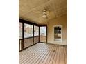 Spacious screened porch with wooden deck and ceiling fan at 1853 Rosedown Ct, Lawrenceville, GA 30043