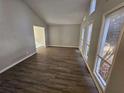 Spacious living room with wood-look floors and large windows at 5085 Rock Glen Dr, Stone Mountain, GA 30088