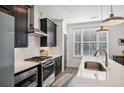 Modern kitchen with stainless steel appliances and white quartz countertops at 3219 Bartee Walk, Suwanee, GA 30024