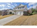 Two-story house with a two-car garage and landscaped yard at 242 Edinburgh Ln, Woodstock, GA 30188