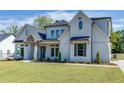 Two-story house with white brick exterior, gray shutters, and a large front yard at 522 Hope Hollow Ln, Loganville, GA 30052