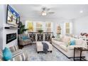 Inviting living room with a fireplace, ceiling fan, plush furniture, and natural light at 269 Whitetail Cir, Canton, GA 30115