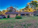 Brick ranch house with screened porch and spacious backyard at 2027 Kensington High St, Lilburn, GA 30047