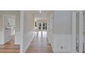Hardwood floor hallway with white wainscoting and doors to other rooms at 1151 Ruby Nelson Ct, Lawrenceville, GA 30043