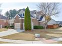 Brick home with a two-car garage and nicely landscaped yard at 2557 Misty Rose Ln, Loganville, GA 30052